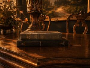 The Holy Bible and Book of Mormon stacked on a table