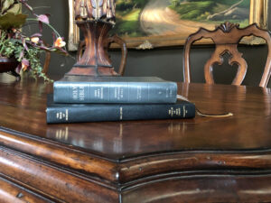 The Holy Bible and the Book of Mormon on a table top.